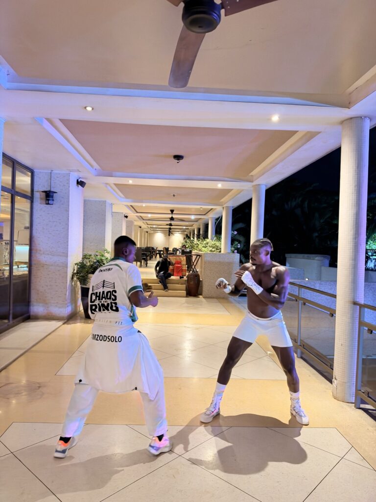 Zodsolo shadow boxes with a corner team member wearing an AfroAlien Fit #IAMZODSOLO top.